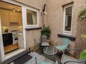 a patio with chairs and a table and a kitchen at The Haven in Morecambe