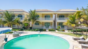 a large house with a swimming pool and a resort at Green Paradise Canoa Quebrada in Canoa Quebrada +3 photos