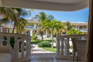 a view from the balcony of a resort with palm trees at Green Paradise Canoa Quebrada in Canoa Quebrada