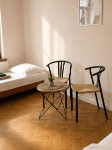 a bedroom with a bed and a table and chairs at Hotel Gryf in Gryfice