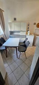 a kitchen with a table and chairs in a room at Apartments Hugo in Malinska +29 photos