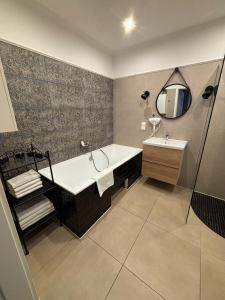 a bathroom with a tub and a sink and a mirror at Szafirowy Dwór Hotel & Restauracja in Gliwice +44 photos