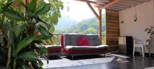 a room with two chairs and a view of a mountain at La cabañita VIP in Minca +16 photos
