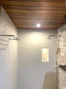 a bathroom with a wall with a light on it at Devshal Eco-Stays in Gupta Kāshi
