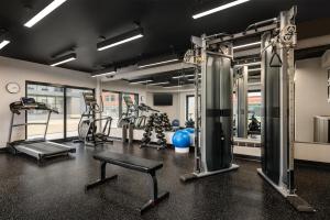 a gym with treadmills and machines in a room at Le Saint Edouard, WorldHotels Distinctive in Quebec City