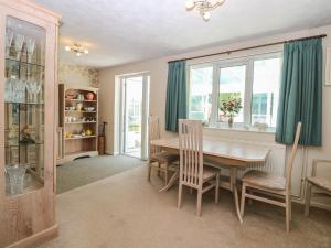 a dining room with a table and chairs and a window at 51 Colin McLean Road in East Dereham +20 photos