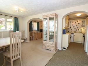 a kitchen and dining room with a table and a refrigerator at 51 Colin McLean Road in East Dereham