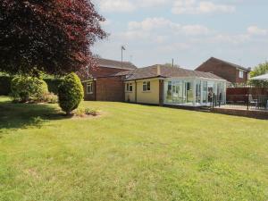 a house with a lawn in front of a house at 51 Colin McLean Road in East Dereham