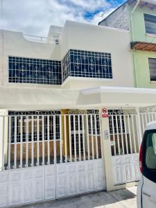 a white house with a white garage door at Centrica y Residencial in Ambato