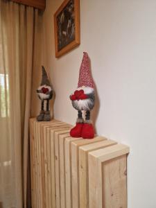 two gnomes sitting on top of a wooden dresser at Casa Campetta in Comano Terme