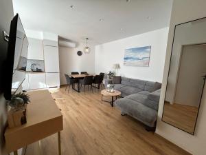 a living room with a couch and a table at Beachfront house Miamore - 10 m from the sea in Pašman