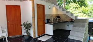 a kitchen with a sink and a stairway at La cabañita VIP in Minca