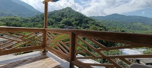 a balcony with a view of the mountains at La cabañita VIP in Minca