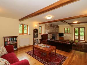 a living room with a couch and a table at Stowey Mead Stables in Bristol