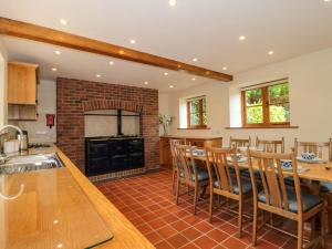 a kitchen with a fireplace and a table and chairs at Stowey Mead Stables in Bristol