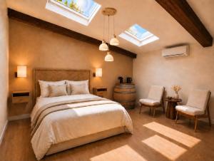 a bedroom with a bed and a chair and skylights at Château Alto Cormeil in Saint-Émilion