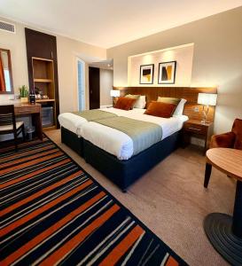 a hotel room with a large bed and a desk at Fenwick Street Hotel by EPIC, Central Rooms Near Waterfront & Liverpool ONE in Liverpool