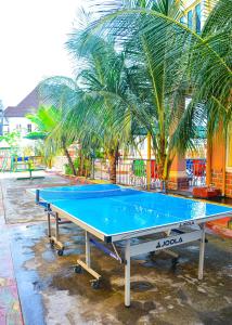 a ping pong table in front of a palm tree at 6A Resort LTD in Owerri