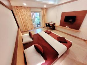 a bedroom with a large bed and a desk at Famafa Hotel in Arambol +19 photos