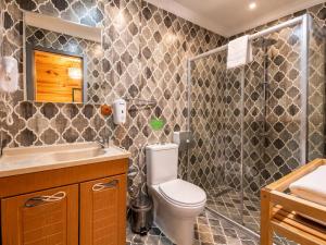 a bathroom with a toilet and a sink and a shower at Ayder Doga Resort in Ayder Yaylasi +50 photos