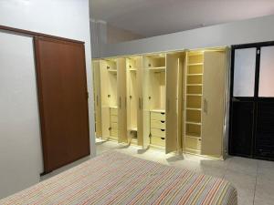 a bedroom with yellow closets in a room at ACOGEDOR DEPa CON GARAGE PRIVADO in Nueva Loja