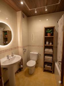 a bathroom with a toilet and a sink at Apartamentos El Cuetu in Llanes +16 photos