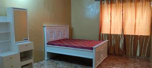 a small bed in a room with a window at Michenzani rooms apartment in Ngambo