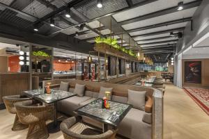 a restaurant with two tables and a couch at Radisson RED Auckland in Auckland