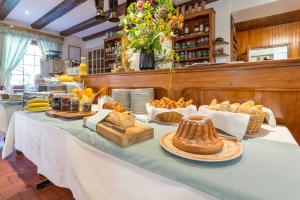 a table with bread and other food on it at L'AO Hôtel & Restaurant L'Aigle d'Or in Rimbach-près-Guebwiller