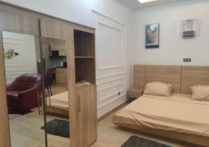 a bedroom with a bed and a chair in it at STUDIO Meublée à Gbodjè in Porto-Novo