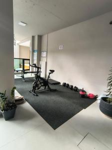 a room with a gym with a treadmill and weights at Das Nações Hotel in Florianópolis
