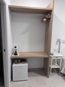 a closet with a wooden shelf in a room at La LLar in Carboneras