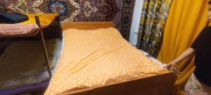 a woman is holding a pillow on a bed at Alima in Ottuk