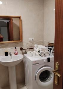 a bathroom with a washing machine and a sink at Apartamentos Amy 3 con vista a mar in Palos de la Frontera +36 photos