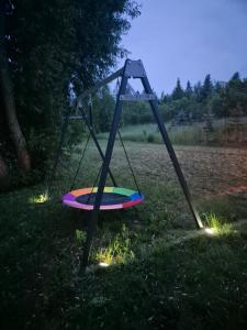 a swing set in the grass in a field at Domek pod Wierzbami in Leleszki