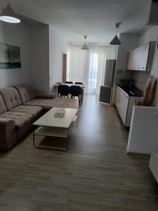 a living room with a couch and a table at Sea View 3-Room Apartment in Olimp