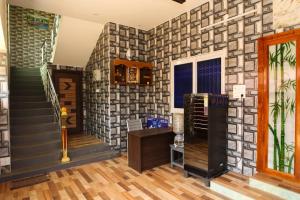 a room with a stone wall with a staircase at Malar Resort in Wodapatti