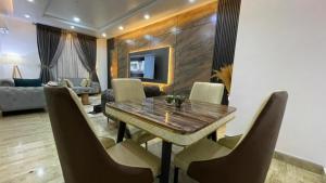a dining room with a table and chairs at Blooms Manor Apartment in Lagos