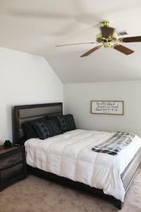 a bedroom with a bed with a ceiling fan at Crooked F Ranch in Stephenville