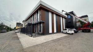 a building with a car parked in front of it at Gatsby Djal in Bishkek