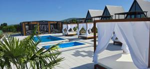 a villa with a swimming pool and a resort at Elysium Lozenets in Lozenets