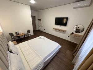a hospital room with a bed and a flat screen tv at Gatsby Djal in Bishkek