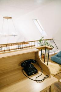 a black phone sitting on the floor under a bed at Demeter Guesthouse WOLF Siklod in Şiclod