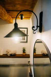 a bathroom with a light hanging over a sink at Demeter Guesthouse WOLF Siklod in Şiclod