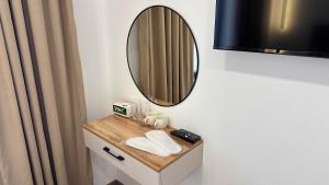 a bathroom with a vanity with a mirror on it at Gatsby Djal in Bishkek +55 photos