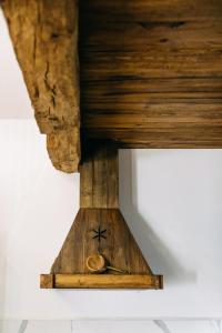 a wooden table with a clock on top of it at Demeter Guesthouse WOLF Siklod in Şiclod