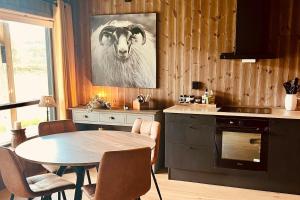 a kitchen with a table and a goat on the wall at New! Mountain apartment close to Hardangervidda in Eidfjord