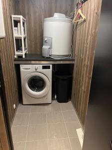 a laundry room with a washer and dryer on a counter at New! Mountain apartment close to Hardangervidda in Eidfjord