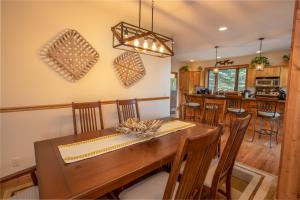 a dining room and kitchen with a wooden table and chairs at Resting on the Ridge in Beech Mountain +25 photos