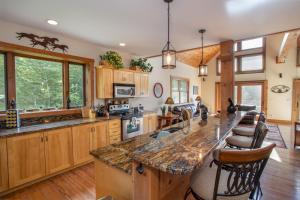 a large kitchen with wooden cabinets and a large island at Resting on the Ridge in Beech Mountain